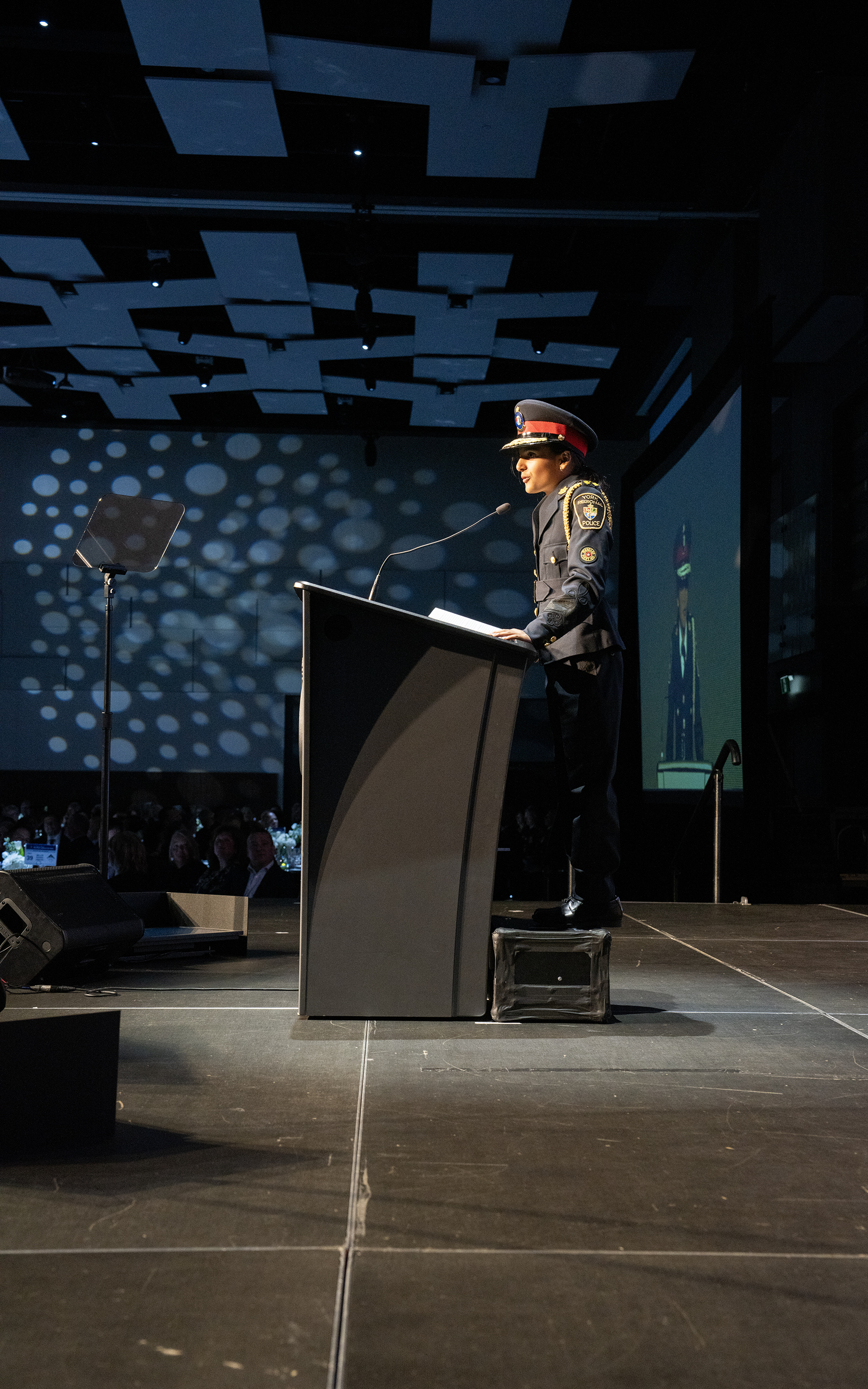 The chief for a day speaks at a podium